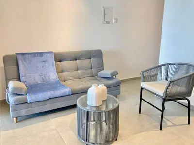 a living room with a couch and a chair at Suite moderna con vista al mar y parque CB 814 in Cartagena de Indias