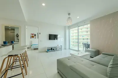 a white living room with a couch and a kitchen at Edificio Morros 3, Beachfront & 2 Bedrooms by Inmobiliaria MFR in Cartagena de Indias
