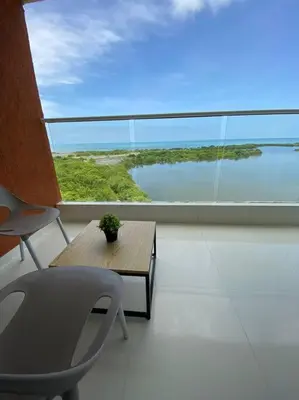 a room with a table and a chair and a large window at Mirador del Mar Playa Mendoza in Tubará
