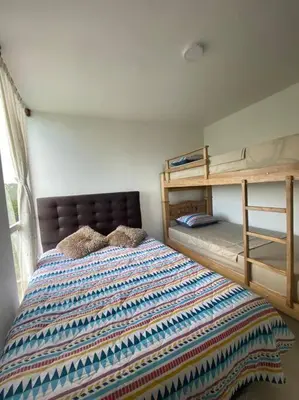 a bedroom with a bed and bunk beds at Mirador del Mar Playa Mendoza in Tubará