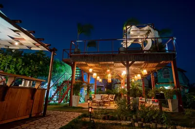 a tree house with a deck at night at Tiny Village Cartagena Boutique Resort in Tierra Bomba