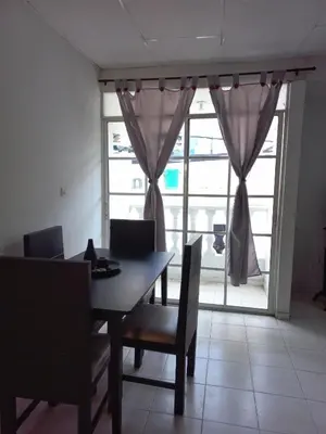 a dining room with a table and chairs and a window at Apartamento hostal oasis in Puerto Colombia