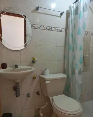 a bathroom with a toilet and a sink and a mirror at Apartamento hostal oasis in Puerto Colombia