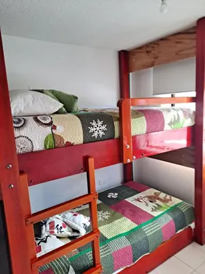 a bedroom with two bunk beds with a ladder at Apartamento para Vacaciones in Cartagena de Indias