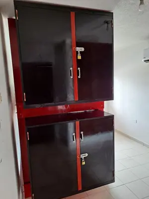 a kitchen with two black cabinets with red trim at Apartamento para Vacaciones in Cartagena de Indias