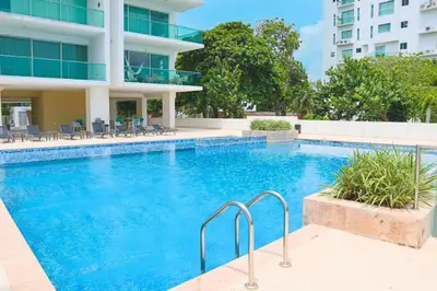 a swimming pool in front of a building at Magico Apartamento Frente al Mar 3 Habitaciones TR51 in Coveñas