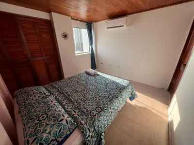 a bedroom with a bed in a room with a window at Cartagena Mar 4You in Cartagena de Indias