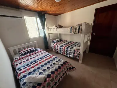 a bedroom with two beds and a bunk bed at Cartagena Mar 4You in Cartagena de Indias