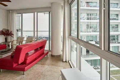 a red couch in a room with windows at Ocean Luxe Morros in Cartagena de Indias