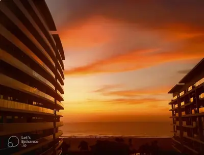 a sunset over the ocean from a building at Ocean Luxe Morros in Cartagena de Indias