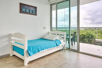a bedroom with a bed and a balcony at Ocean Luxe Morros in Cartagena de Indias