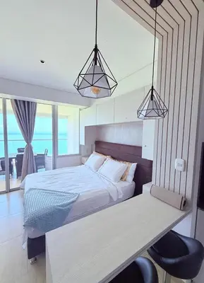 a bedroom with a bed and a desk with two lights at Apartamento con vista al mar in Cartagena de Indias