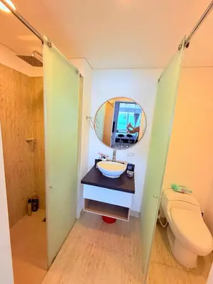 a bathroom with a sink and a toilet and a mirror at Apartamento con vista al mar in Cartagena de Indias