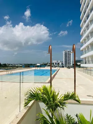 a large swimming pool in a building with a building at Apartamento con vista al mar in Cartagena de Indias