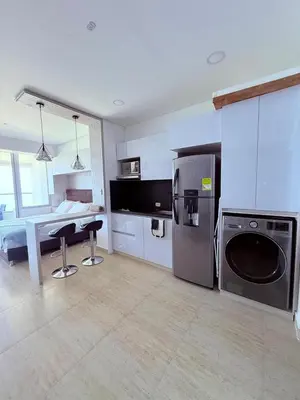 a kitchen with a refrigerator and a table in it at Apartamento con vista al mar in Cartagena de Indias