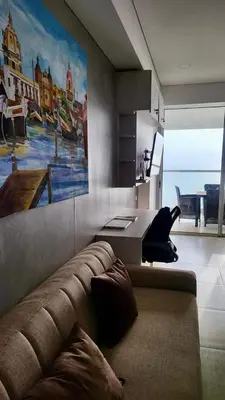 a living room with a couch and a painting on the wall at Apartamento con vista al mar in Cartagena de Indias