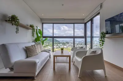 a living room with white furniture and large windows at Cabrero Centro Tropical - Con vista al mar in Cartagena de Indias