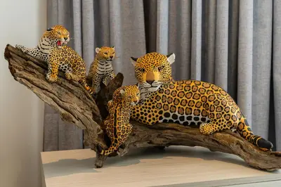 a group of four leopards sitting on a tree branch at Lujoso Apartamento Baia Kristal in Cartagena de Indias