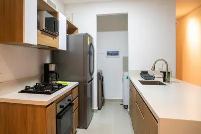 a kitchen with a stainless steel refrigerator and a sink at Lujoso Apartamento Baia Kristal in Cartagena de Indias