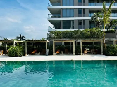 a swimming pool in front of a building at Mágico Apartamento - Vista Infinita al Mar in Cartagena de Indias