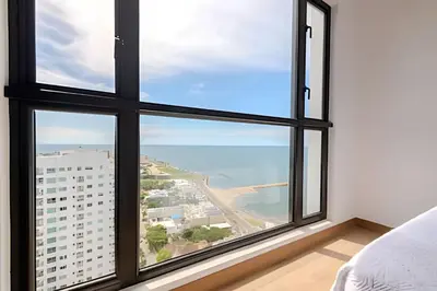 a bedroom with a large window with a view of the ocean at Luxury Exlusive Panoramic View & Historic Center in Cartagena de Indias