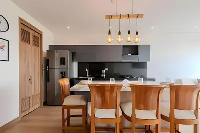 a kitchen with a table and chairs and a kitchen with black at Luxury Exlusive Panoramic View & Historic Center in Cartagena de Indias