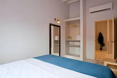 a bedroom with a large bed with a blue blanket at Apartamento Bovedas, Aldaba Selection in Cartagena de Indias