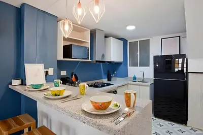 a kitchen with blue walls and a counter with bowls on it at Apartamento Bovedas, Aldaba Selection in Cartagena de Indias