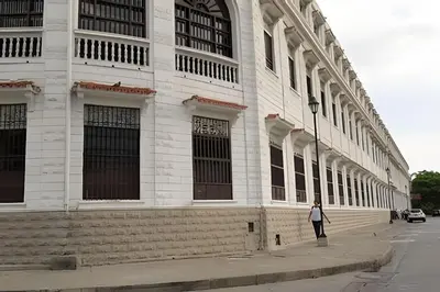 a woman standing in front of a building at Apartamento Bovedas, Aldaba Selection in Cartagena de Indias