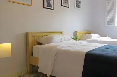 two beds sitting next to each other in a bedroom at Apartamento Bovedas, Aldaba Selection in Cartagena de Indias