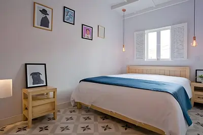 a white bedroom with a bed and a window at Apartamento Bovedas, Aldaba Selection in Cartagena de Indias