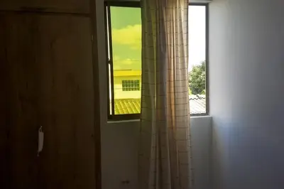a window in a room with a view of a building at Apto 202, área mtana de Barranquilla in Soledad