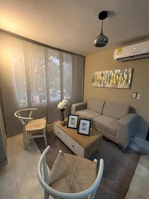 a living room with a couch and a table at Apartamento en Alameda Barranquilla in Barranquilla