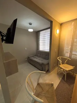 a living room with a couch and a tv at Apartamento en Alameda Barranquilla in Barranquilla