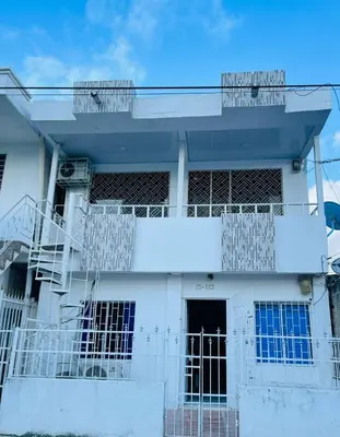 a white building with a staircase in front of it at Apto céntrico torices 1 piso 2 habitaciones in Cartagena de Indias