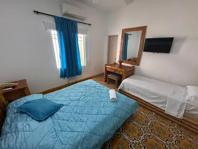 a bedroom with a large bed and a mirror at Hotel Casa Confort Cartagena in Cartagena de Indias