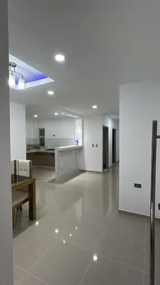 a large white room with a table and a kitchen at Casa Cristal Apto x Dia! in Aracataca