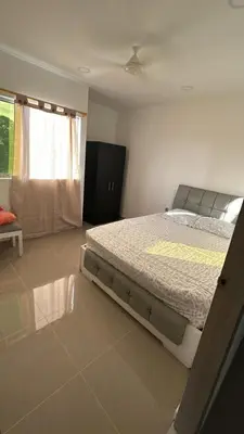 a bedroom with a large bed and a window at Casa Cristal Apto x Dia! in Aracataca