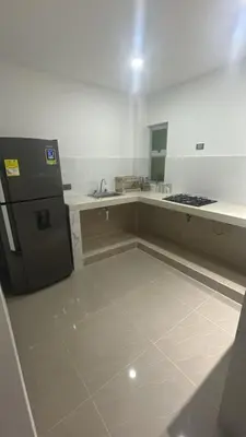 an empty kitchen with a refrigerator and a sink at Casa Cristal Apto x Dia! in Aracataca