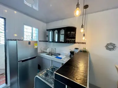 a kitchen with a refrigerator and a counter top at Apartamento céntrico Torices in Cartagena de Indias