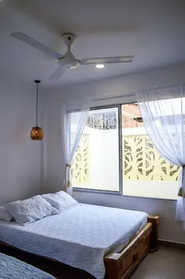 a bedroom with a bed and a window at Casa de Playa ROSANI in Coveñas