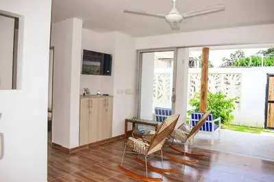a living room with chairs and a ceiling fan at Casa de Playa ROSANI in Coveñas