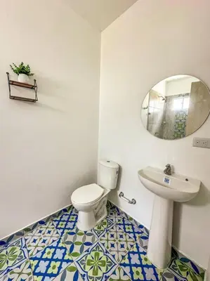 a bathroom with a toilet and a sink and a mirror at Casa de Playa ROSANI in Coveñas