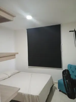 a room with a bed and a flat screen tv at Jardin imperial, habitaciones economica en apartamento familiar zona tranquila WIFI in Cartagena de Indias