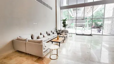 a living room with a couch and tables and windows at PLAYA BELLO HORIZONTE 