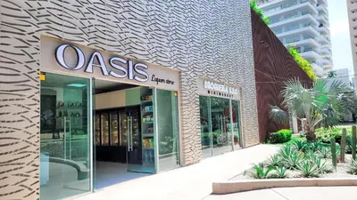 a oasis store with a sign on the side of a building at PLAYA BELLO HORIZONTE 