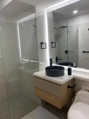 a bathroom with a sink and a glass shower at Apartamento Hotel estelar in Barranquilla