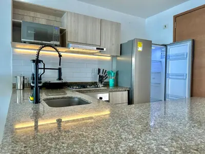 a kitchen with a sink and a refrigerator at by Calamari Homes - Altamar 27B1 near walled city in Cartagena de Indias