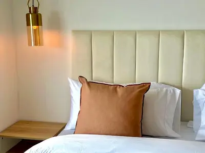 a bedroom with a bed with a pillow and a lamp at by Calamari Homes - Altamar 27B1 near walled city in Cartagena de Indias