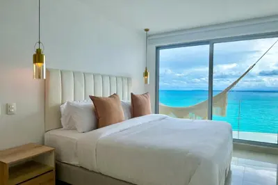 a bedroom with a large bed and a large window at by Calamari Homes - Altamar 27B1 near walled city in Cartagena de Indias